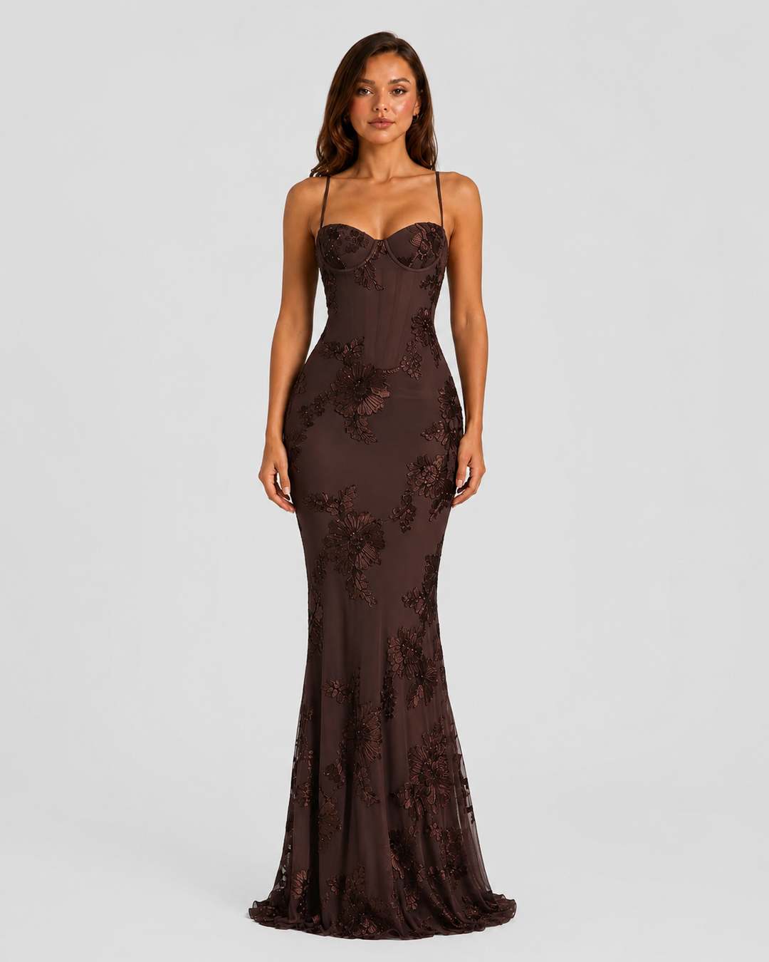 Woman wearing a floral embroidered corset maxi dress with delicate straps and a flowing full-length skirt, styled for weddings and formal occasions.