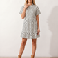 Women's Romy Polka Dot Ruffle Detail Mini Dress in lightweight woven chiffon featuring an all-over polka dot print, ruffled mock neckline, flutter sleeves, defined waist and tiered ruffle mini skirt, ideal for weddings, garden parties and elegant occasion wear.