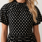 Women's Romy Polka Dot Ruffle Detail Mini Dress in lightweight woven chiffon featuring an all-over polka dot print, ruffled mock neckline, flutter sleeves, defined waist and tiered ruffle mini skirt, ideal for weddings, garden parties and elegant occasion wear.