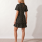 Women's Romy Polka Dot Ruffle Detail Mini Dress in lightweight woven chiffon featuring an all-over polka dot print, ruffled mock neckline, flutter sleeves, defined waist and tiered ruffle mini skirt, ideal for weddings, garden parties and elegant occasion wear.