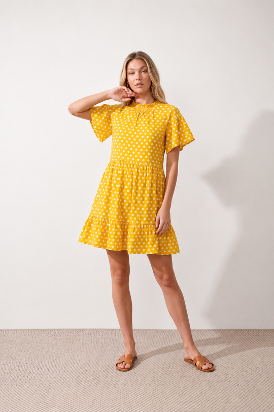 Women's Romy Polka Dot Ruffle Detail Mini Dress in lightweight woven chiffon featuring an all-over polka dot print, ruffled mock neckline, flutter sleeves, defined waist and tiered ruffle mini skirt, ideal for weddings, garden parties and elegant occasion wear.