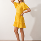 Women's Romy Polka Dot Ruffle Detail Mini Dress in lightweight woven chiffon featuring an all-over polka dot print, ruffled mock neckline, flutter sleeves, defined waist and tiered ruffle mini skirt, ideal for weddings, garden parties and elegant occasion wear.