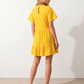 Women's Romy Polka Dot Ruffle Detail Mini Dress in lightweight woven chiffon featuring an all-over polka dot print, ruffled mock neckline, flutter sleeves, defined waist and tiered ruffle mini skirt, ideal for weddings, garden parties and elegant occasion wear.