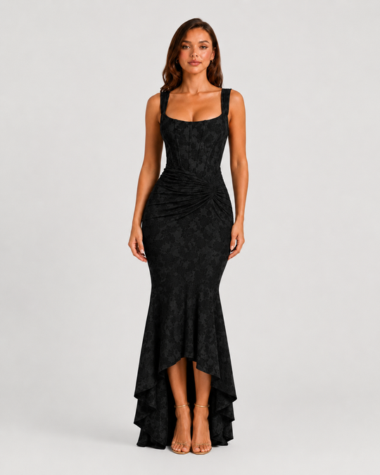 Woman wearing a textured floral corset maxi dress featuring a structured bodice, ruched waist, and dramatic high-low fishtail hem for elegant evening occasions.