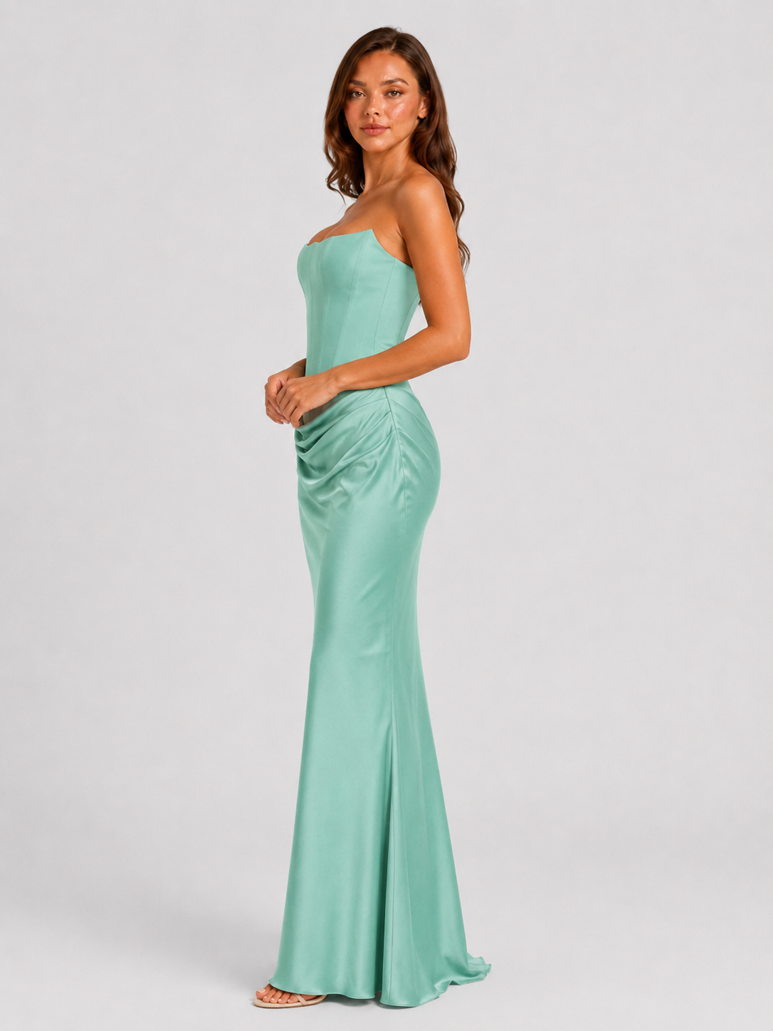 Women's strapless satin gown featuring a draped waist, sculpted fitted silhouette, and elegant floor-length design in a lustrous satin finish.
