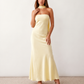 Woman wearing the Diana satin strapless maxi dress featuring a square neckline, scarf-style choker tie, open back with draped detail, and a floor-length fitted silhouette in a smooth satin finish.
