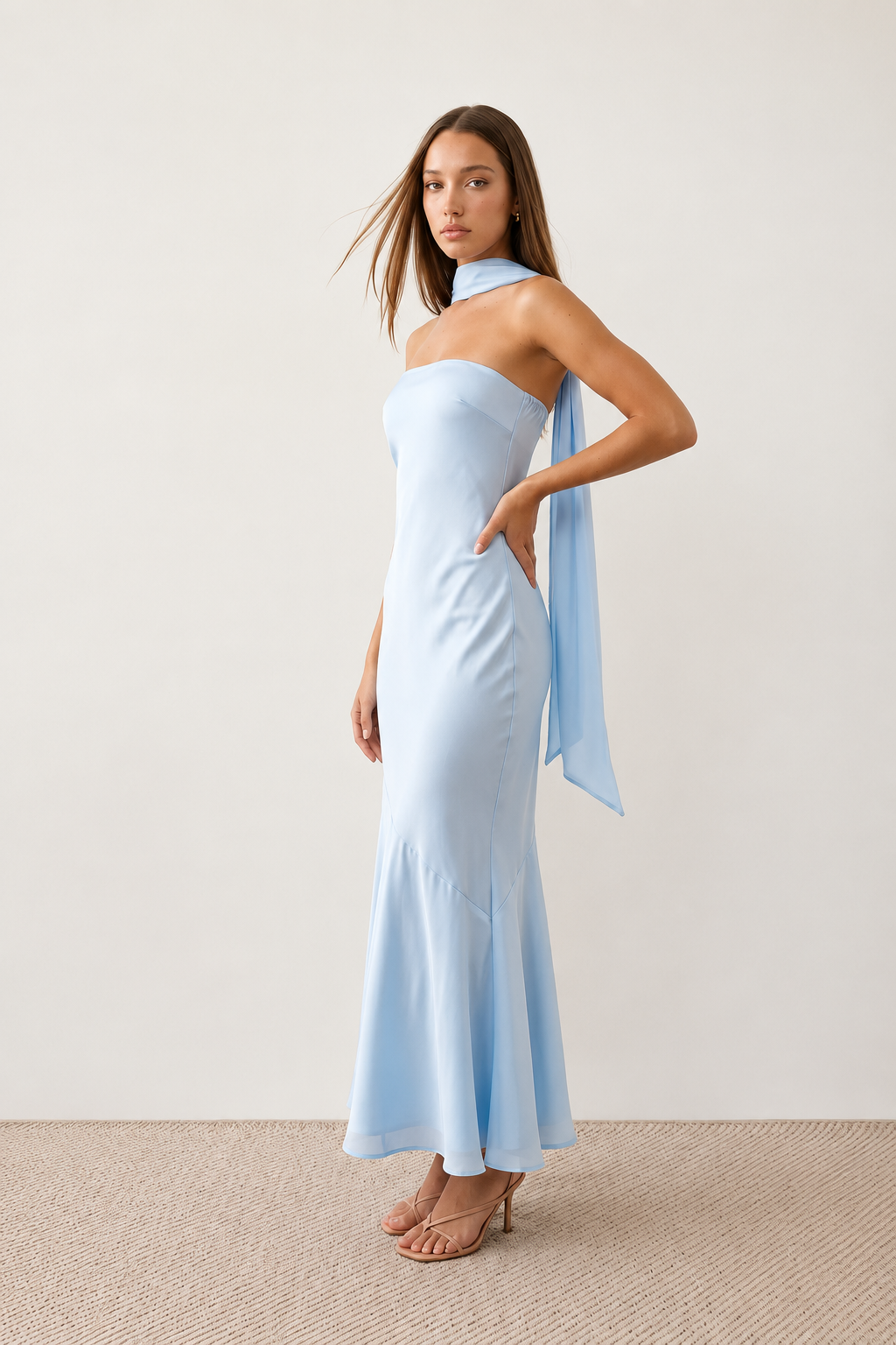 Woman wearing the Diana satin strapless maxi dress featuring a square neckline, scarf-style choker tie, open back with draped detail, and a floor-length fitted silhouette in a smooth satin finish.