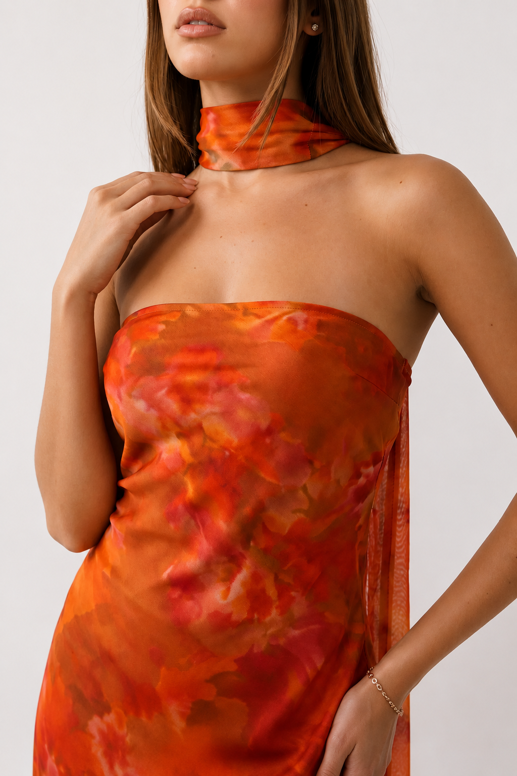 Woman wearing the Diana satin strapless maxi dress featuring a square neckline, scarf-style choker tie, open back with draped detail, and a floor-length fitted silhouette in a smooth satin finish.