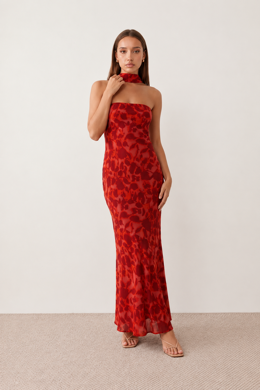 Woman wearing the Diana satin strapless maxi dress featuring a square neckline, scarf-style choker tie, open back with draped detail, and a floor-length fitted silhouette in a smooth satin finish.