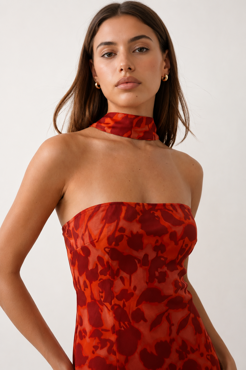 Woman wearing the Diana satin strapless maxi dress featuring a square neckline, scarf-style choker tie, open back with draped detail, and a floor-length fitted silhouette in a smooth satin finish.