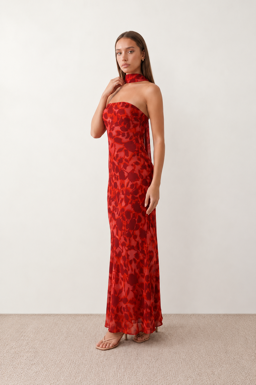 Woman wearing the Diana satin strapless maxi dress featuring a square neckline, scarf-style choker tie, open back with draped detail, and a floor-length fitted silhouette in a smooth satin finish.