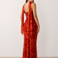 Woman wearing the Diana satin strapless maxi dress featuring a square neckline, scarf-style choker tie, open back with draped detail, and a floor-length fitted silhouette in a smooth satin finish.
