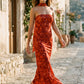 Woman wearing the Diana satin strapless maxi dress featuring a square neckline, scarf-style choker tie, open back with draped detail, and a floor-length fitted silhouette in a smooth satin finish.