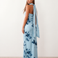 Woman wearing the Diana satin strapless maxi dress featuring a square neckline, scarf-style choker tie, open back with draped detail, and a floor-length fitted silhouette in a smooth satin finish.