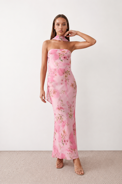Woman wearing the Diana satin strapless maxi dress featuring a square neckline, scarf-style choker tie, open back with draped detail, and a floor-length fitted silhouette in a smooth satin finish.