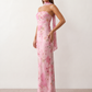 Woman wearing the Diana satin strapless maxi dress featuring a square neckline, scarf-style choker tie, open back with draped detail, and a floor-length fitted silhouette in a smooth satin finish.