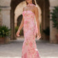 Woman wearing the Diana satin strapless maxi dress featuring a square neckline, scarf-style choker tie, open back with draped detail, and a floor-length fitted silhouette in a smooth satin finish.
