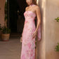 Woman wearing the Diana satin strapless maxi dress featuring a square neckline, scarf-style choker tie, open back with draped detail, and a floor-length fitted silhouette in a smooth satin finish.