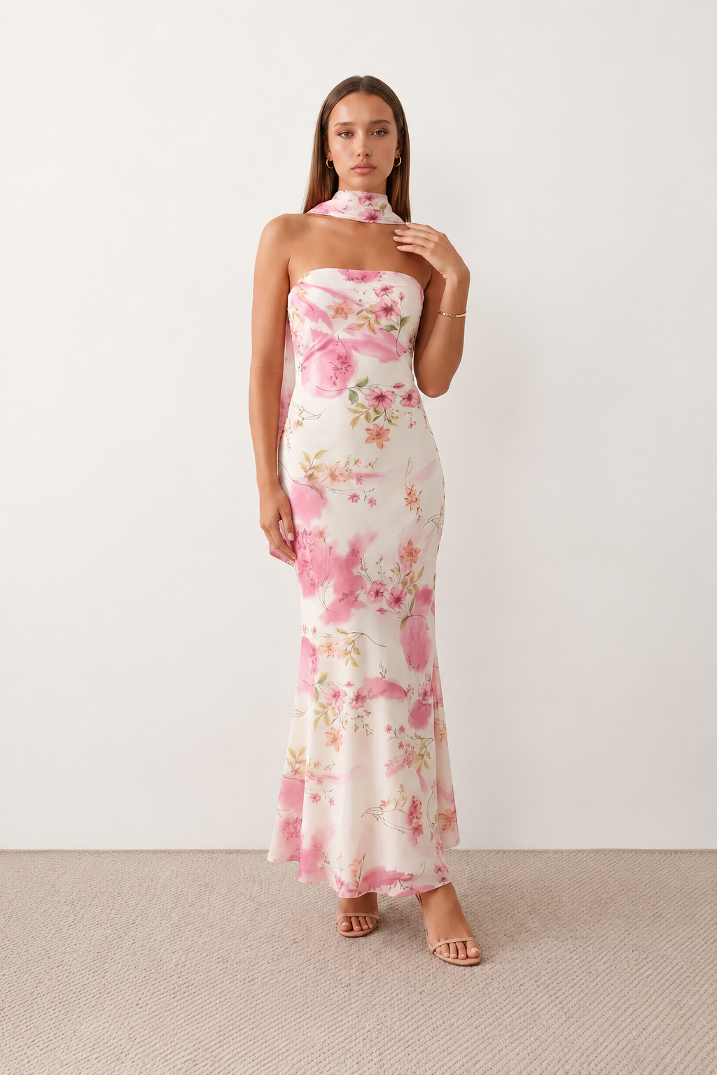 Woman wearing the Diana satin strapless maxi dress featuring a square neckline, scarf-style choker tie, open back with draped detail, and a floor-length fitted silhouette in a smooth satin finish.