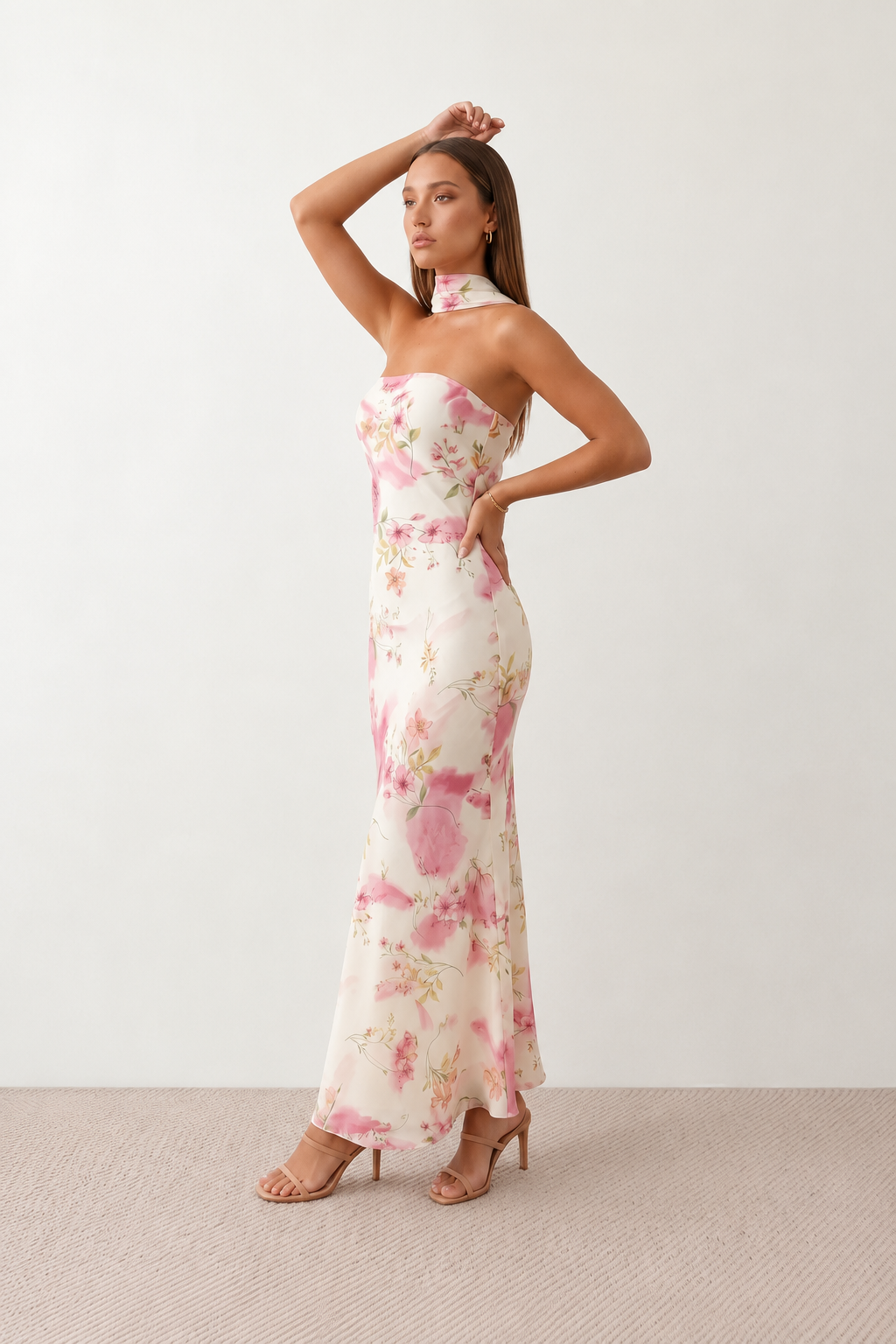 Woman wearing the Diana satin strapless maxi dress featuring a square neckline, scarf-style choker tie, open back with draped detail, and a floor-length fitted silhouette in a smooth satin finish.