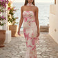 Woman wearing the Diana satin strapless maxi dress featuring a square neckline, scarf-style choker tie, open back with draped detail, and a floor-length fitted silhouette in a smooth satin finish.