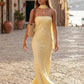 Woman wearing the Diana satin strapless maxi dress featuring a square neckline, scarf-style choker tie, open back with draped detail, and a floor-length fitted silhouette in a smooth satin finish.