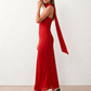 Woman wearing the Diana satin strapless maxi dress featuring a square neckline, scarf-style choker tie, open back with draped detail, and a floor-length fitted silhouette in a smooth satin finish.