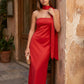 Woman wearing the Diana satin strapless maxi dress featuring a square neckline, scarf-style choker tie, open back with draped detail, and a floor-length fitted silhouette in a smooth satin finish.