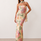 Woman wearing the Diana satin strapless maxi dress featuring a square neckline, scarf-style choker tie, open back with draped detail, and a floor-length fitted silhouette in a smooth satin finish.