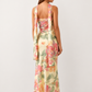 Woman wearing the Diana satin strapless maxi dress featuring a square neckline, scarf-style choker tie, open back with draped detail, and a floor-length fitted silhouette in a smooth satin finish.