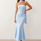 Woman wearing the Diana satin strapless maxi dress featuring a square neckline, scarf-style choker tie, open back with draped detail, and a floor-length fitted silhouette in a smooth satin finish.