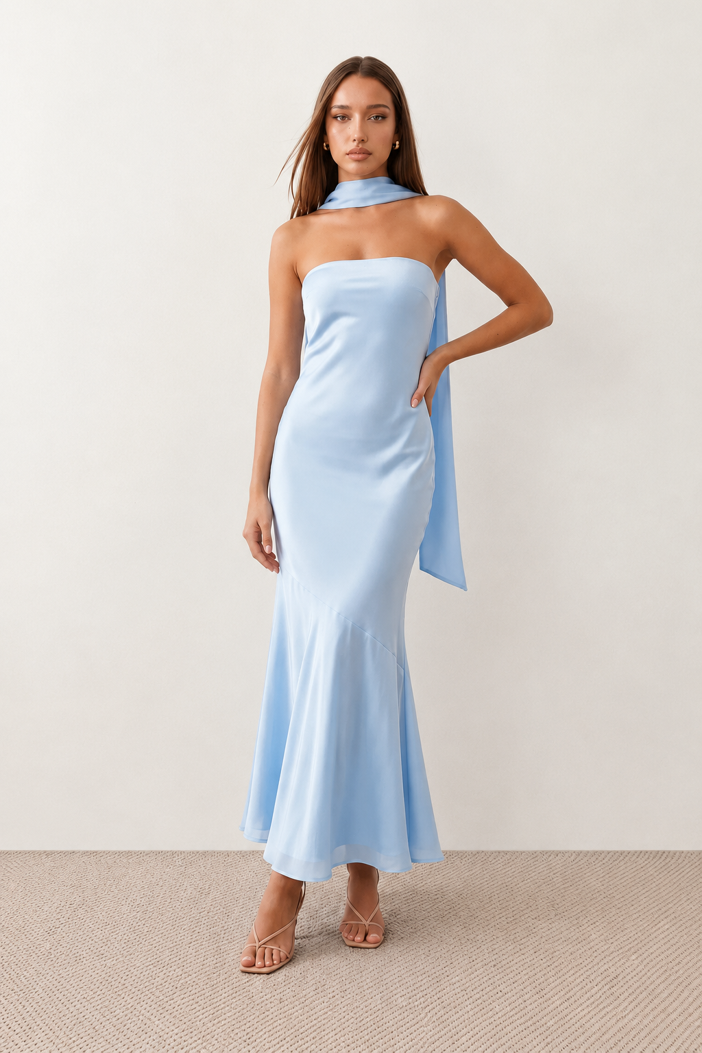Woman wearing the Diana satin strapless maxi dress featuring a square neckline, scarf-style choker tie, open back with draped detail, and a floor-length fitted silhouette in a smooth satin finish.