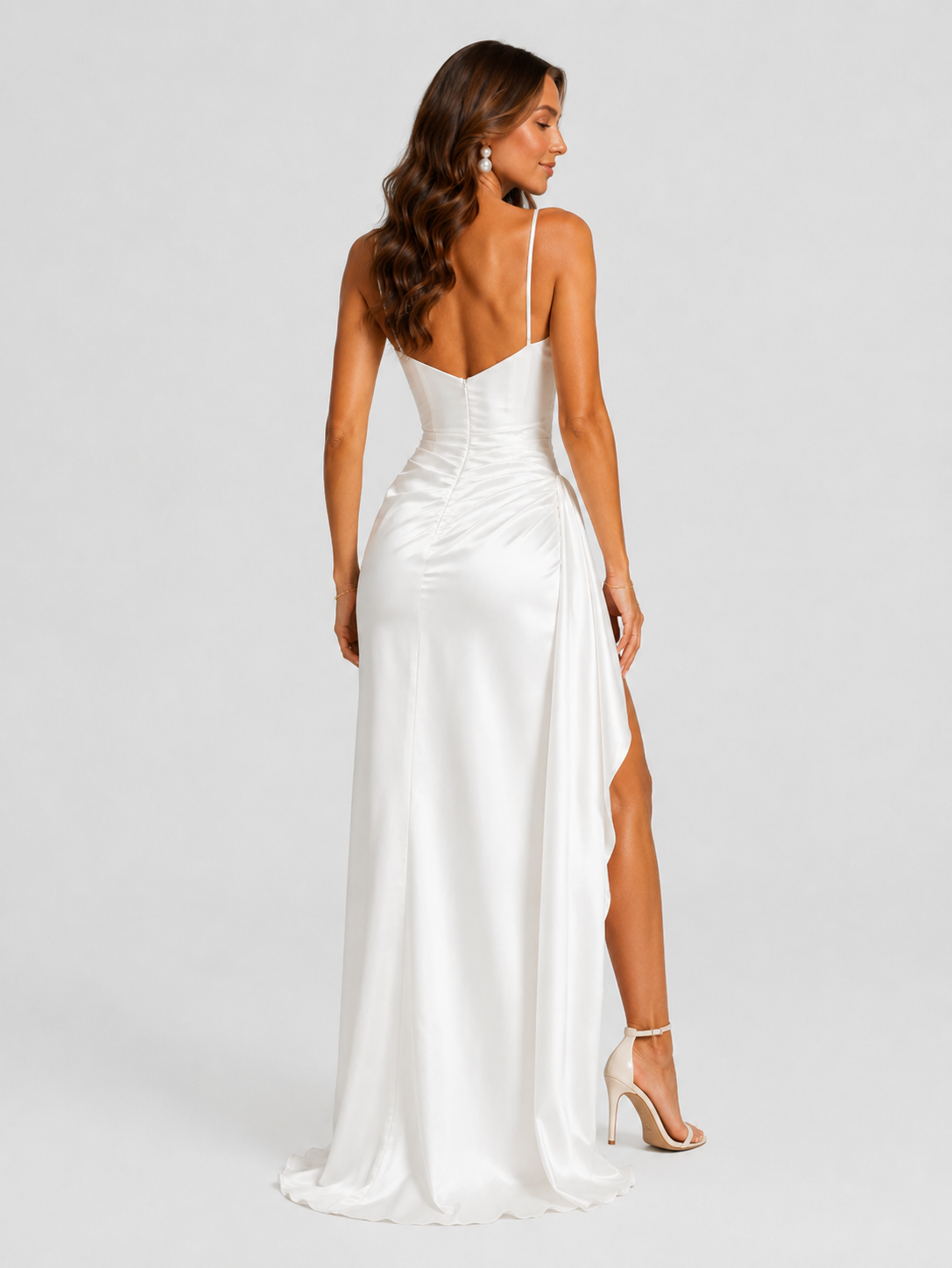 Women’s draped satin maxi dress featuring a fitted bodice, asymmetric waist draping, and a flowing split skirt for elegant evening occasions.