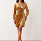 Women's Lidija sequined ruched mini dress with a wrap-style V-neckline, long sleeves, fitted silhouette, front ruching, asymmetric hem, and subtle front slit, ideal for parties, cocktail events, and festive occasions.