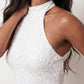 Woman wearing the Shanna Sequined Halter Mini Dress featuring all-over shimmering sequins, an elegant halter neckline, striking open back, fitted sheath silhouette, and soft feather-trimmed mini hem, perfect for parties, cocktail events and festive occasions.