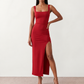 Woman wearing the Skye Open Back Fitted Maxi Dress featuring a square neckline, wide shoulder straps, ruched bodycon silhouette, open back with a smocked panel and tie-bow fastening, thigh-high side split, and floor-length maxi design, perfect for weddings, cocktail parties and formal occasions.