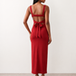 Woman wearing the Skye Open Back Fitted Maxi Dress featuring a square neckline, wide shoulder straps, ruched bodycon silhouette, open back with a smocked panel and tie-bow fastening, thigh-high side split, and floor-length maxi design, perfect for weddings, cocktail parties and formal occasions.