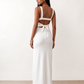 Woman wearing the Skye Open Back Fitted Maxi Dress featuring a square neckline, wide shoulder straps, ruched bodycon silhouette, open back with a smocked panel and tie-bow fastening, thigh-high side split, and floor-length maxi design, perfect for weddings, cocktail parties and formal occasions.