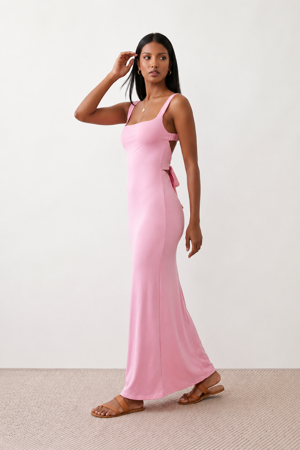 Woman wearing the Skye Open Back Fitted Maxi Dress featuring a square neckline, wide shoulder straps, ruched bodycon silhouette, open back with a smocked panel and tie-bow fastening, thigh-high side split, and floor-length maxi design, perfect for weddings, cocktail parties and formal occasions.