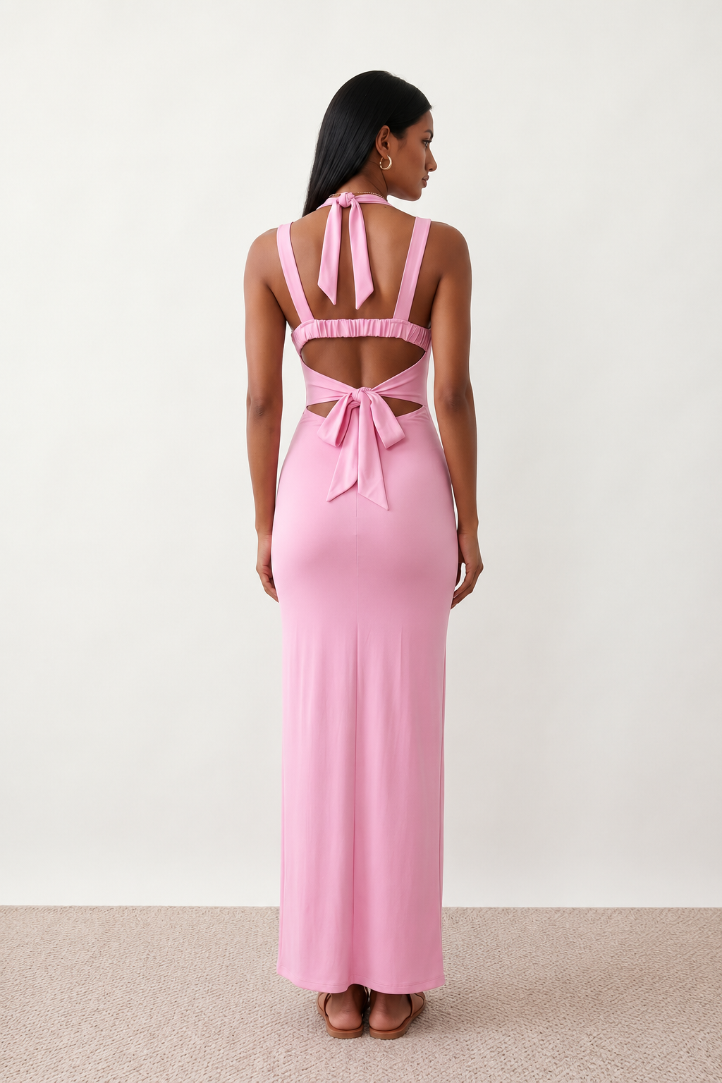 Woman wearing the Skye Open Back Fitted Maxi Dress featuring a square neckline, wide shoulder straps, ruched bodycon silhouette, open back with a smocked panel and tie-bow fastening, thigh-high side split, and floor-length maxi design, perfect for weddings, cocktail parties and formal occasions.