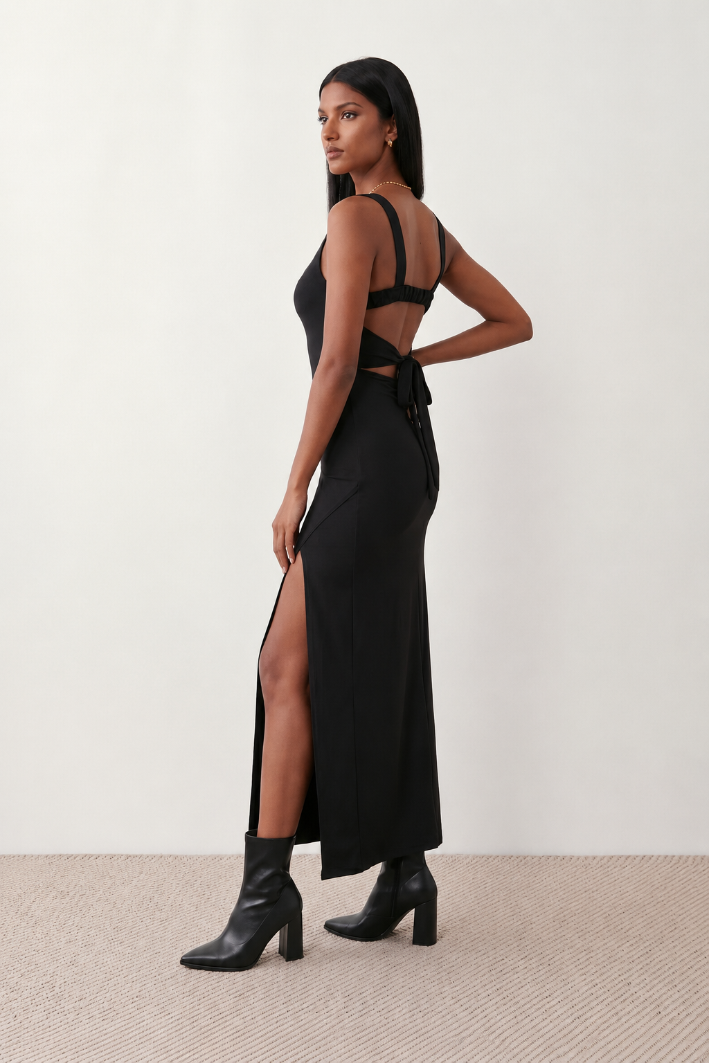Woman wearing the Skye Open Back Fitted Maxi Dress featuring a square neckline, wide shoulder straps, ruched bodycon silhouette, open back with a smocked panel and tie-bow fastening, thigh-high side split, and floor-length maxi design, perfect for weddings, cocktail parties and formal occasions.