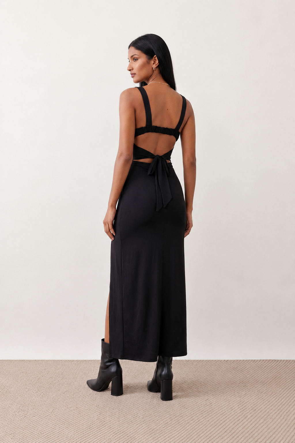 Woman wearing the Skye Open Back Fitted Maxi Dress featuring a square neckline, wide shoulder straps, ruched bodycon silhouette, open back with a smocked panel and tie-bow fastening, thigh-high side split, and floor-length maxi design, perfect for weddings, cocktail parties and formal occasions.