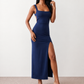 Woman wearing the Skye Open Back Fitted Maxi Dress featuring a square neckline, wide shoulder straps, ruched bodycon silhouette, open back with a smocked panel and tie-bow fastening, thigh-high side split, and floor-length maxi design, perfect for weddings, cocktail parties and formal occasions.
