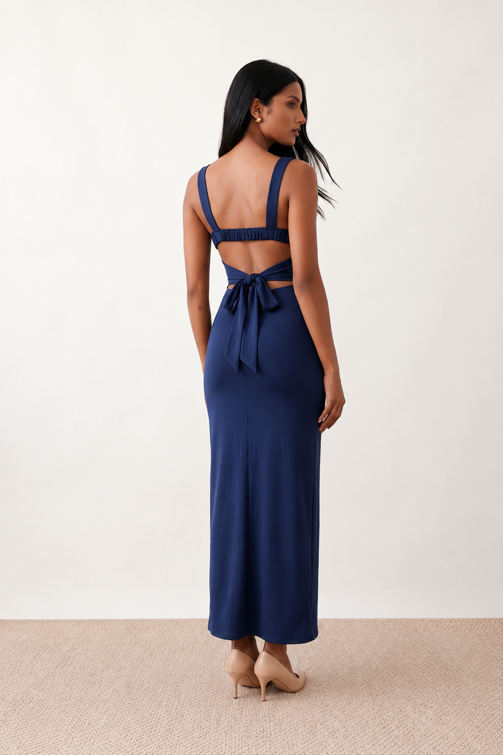 Woman wearing the Skye Open Back Fitted Maxi Dress featuring a square neckline, wide shoulder straps, ruched bodycon silhouette, open back with a smocked panel and tie-bow fastening, thigh-high side split, and floor-length maxi design, perfect for weddings, cocktail parties and formal occasions.