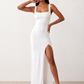 Woman wearing the Skye Open Back Fitted Maxi Dress featuring a square neckline, wide shoulder straps, ruched bodycon silhouette, open back with a smocked panel and tie-bow fastening, thigh-high side split, and floor-length maxi design, perfect for weddings, cocktail parties and formal occasions.