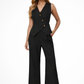 Woman wearing a black sleeveless blazer and wide-leg pants on a white background