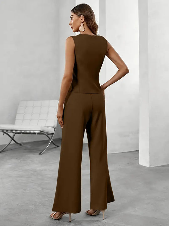 Woman wearing a brown jumpsuit in a minimalistic room.
