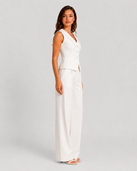 Woman wearing a sleeveless tailored waistcoat with high-waisted wide-leg trousers in a coordinated two-piece set, featuring a relaxed elegant silhouette and modern tailoring.