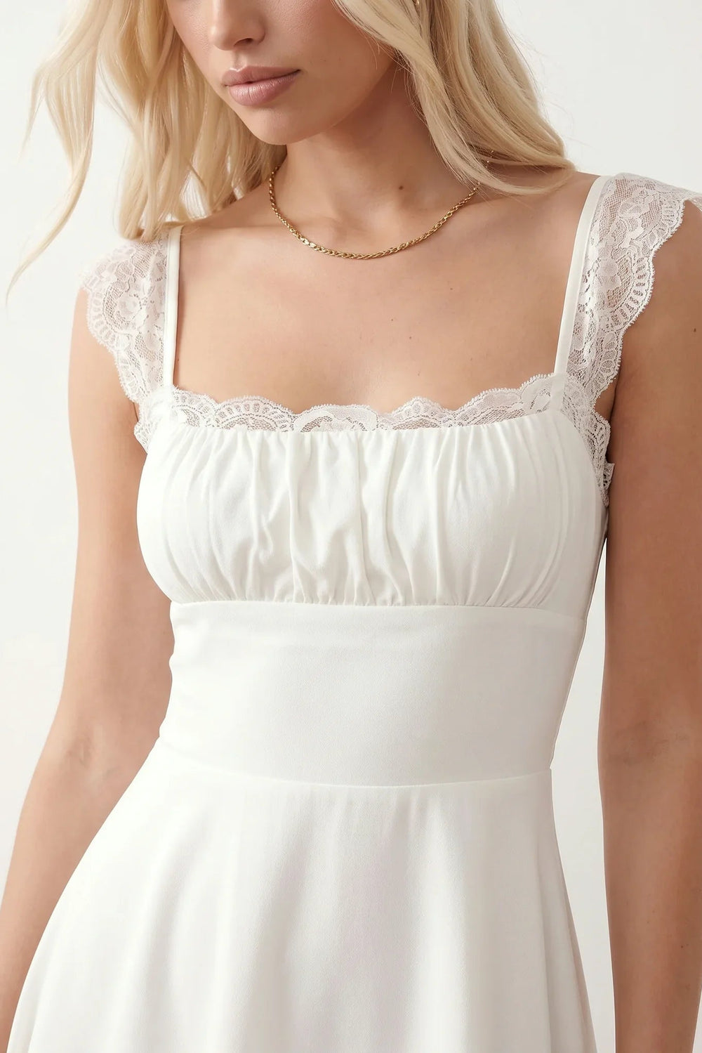 Women's Soraia Lace Lace-Up Mini Dress featuring elegant floral lace, a square neckline with a ruched bust, scalloped cap sleeves, a corset-style lace-up back, and a flattering A-line mini skirt finished with a scalloped lace hem, perfect for weddings, race days, garden parties and special occasions.