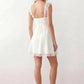 Women's Soraia Lace Lace-Up Mini Dress featuring elegant floral lace, a square neckline with a ruched bust, scalloped cap sleeves, a corset-style lace-up back, and a flattering A-line mini skirt finished with a scalloped lace hem, perfect for weddings, race days, garden parties and special occasions.